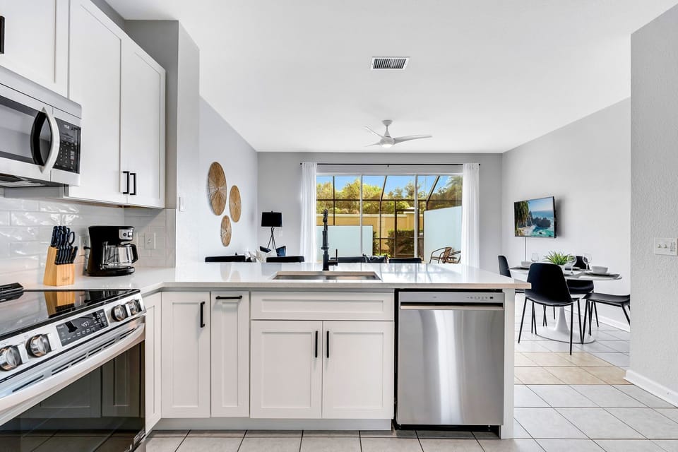 Open concept with a view of the private lanai and splash pool from the kitchen