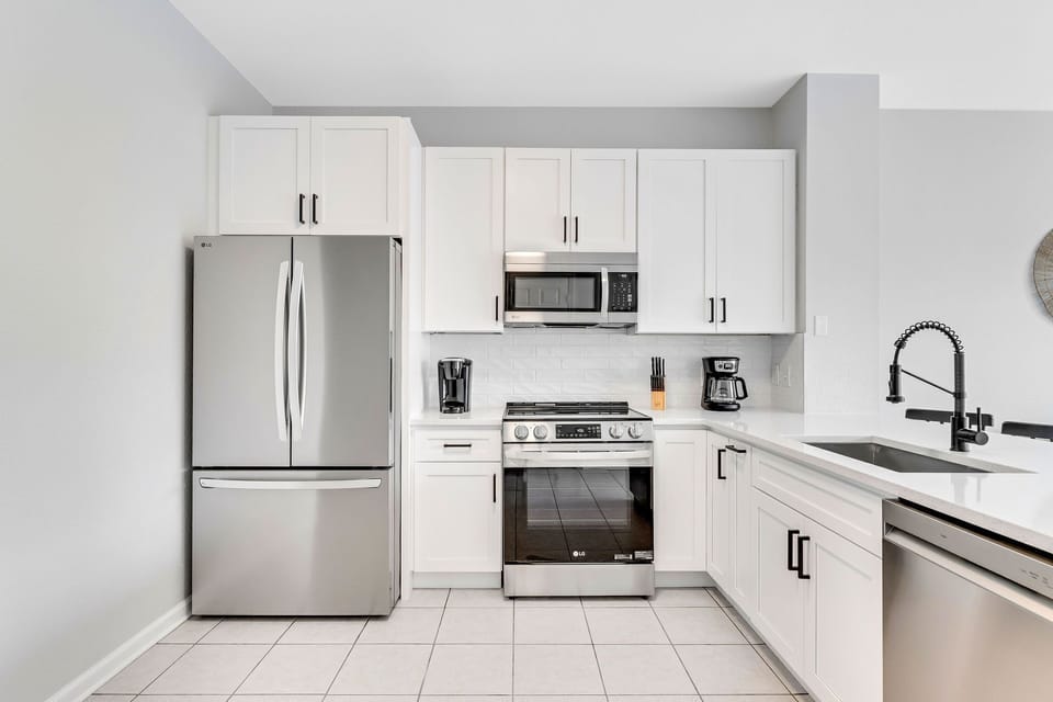 Brand new kitchen with stainless steel LG appliances, cabinets, quartz counters.