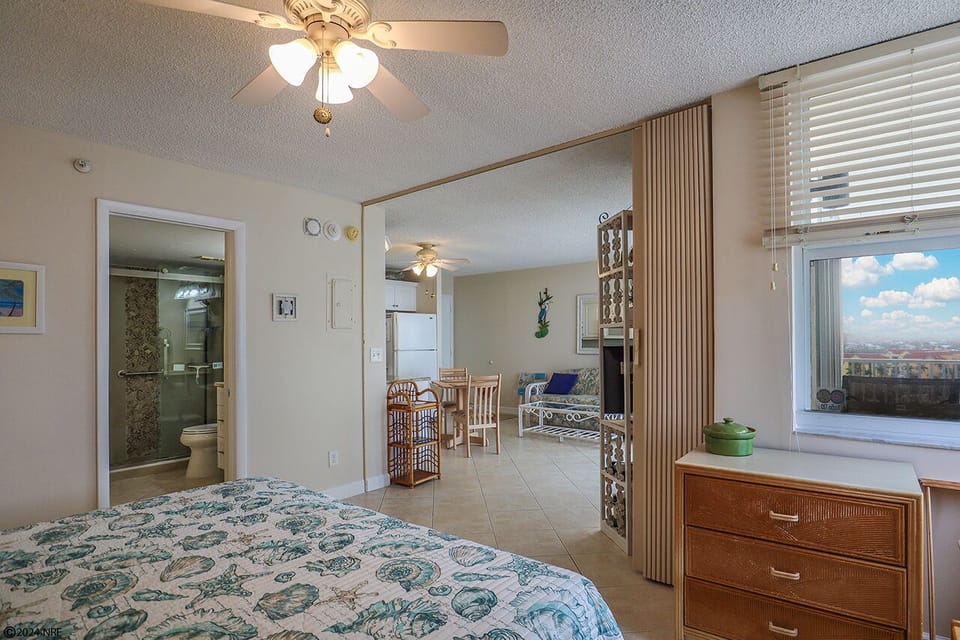 Bedroom has a folding partition to divide the bedroom from the living area