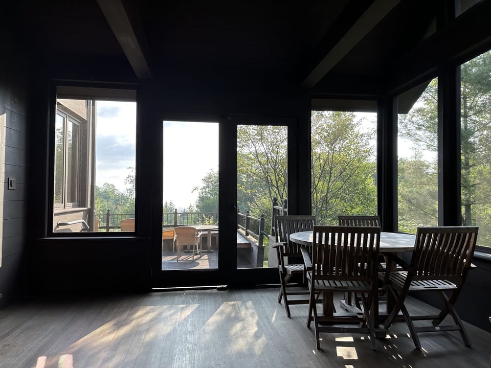 Screened in porch looking out to deck
