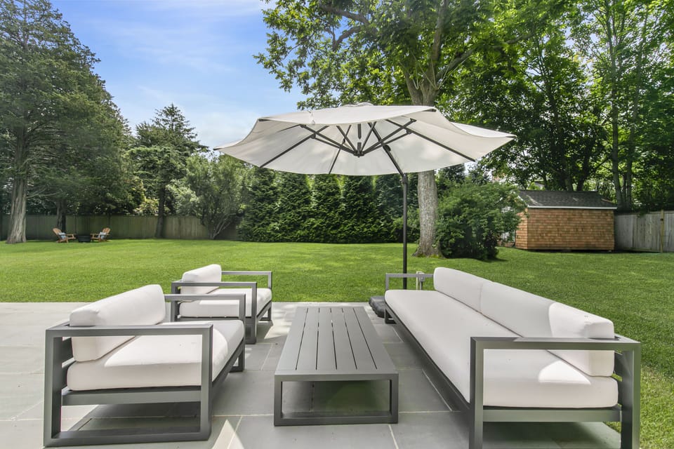 Outdoor seating area, Shed with beach items in the distant right. Gated Property