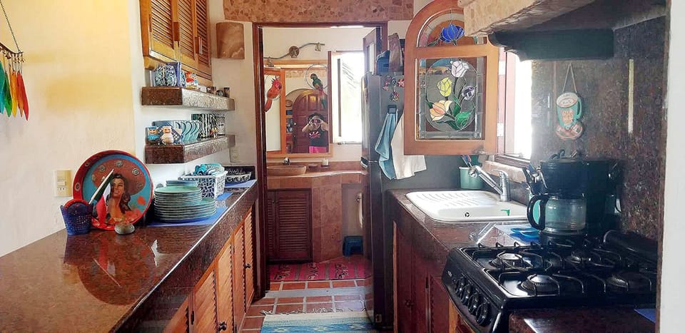 The kitchen is stocked with dishes and everything you need to prepare a meal.