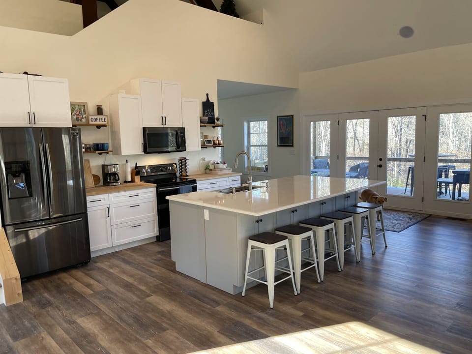 Kitchen island seats up to 8, French doors leading to large screened-in deck