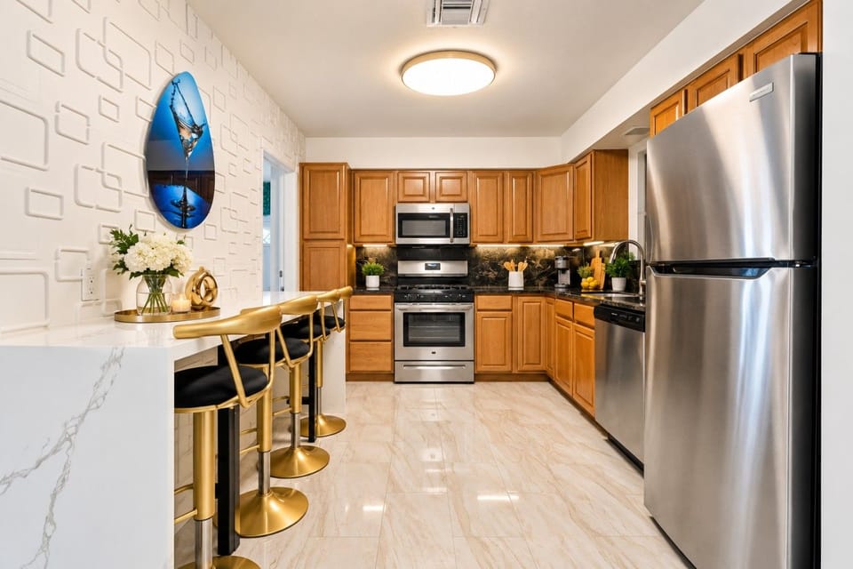 Fully Equipped Gourmet Kitchen! Stainless steel appliances, granite countertops & stylish gold bar seating for 4. Perfect for cooking family meals or entertaining guests. Part of Hollywood Beach villa with game rooms, hot tub & beach just 3min away!