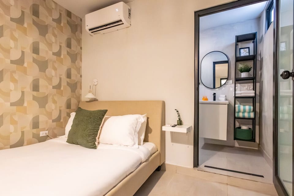 This suite features a queen bed, AC and tv in the bedroom.