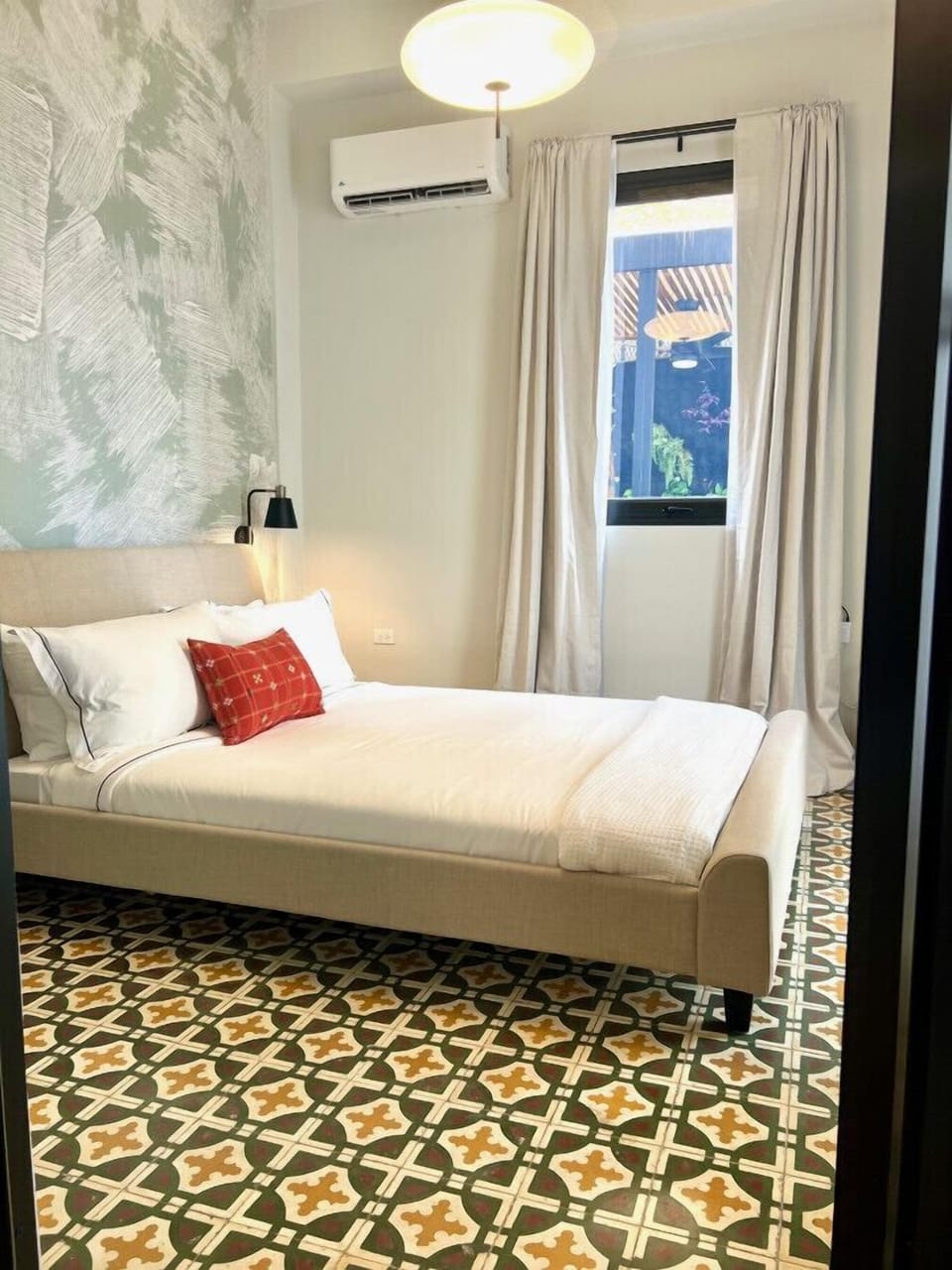 First bedroom, door to balcony, creole tiles