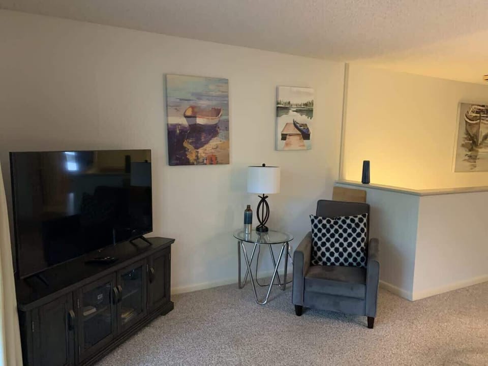 Cozy living room with a large TV and comfortable seating — perfect for movie nights or relaxing after a busy day.