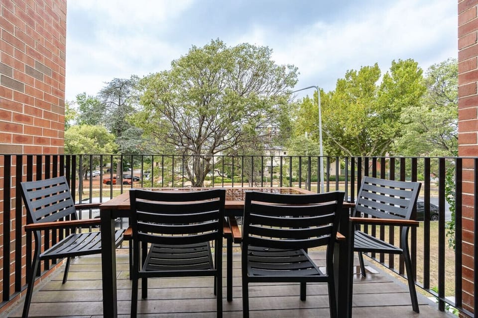 Step outside to enjoy a serene environment with a 4-seater table that offers a picturesque view of the greenery. It`s an ideal spot for morning coffee or simply soaking in the natural surroundings.
