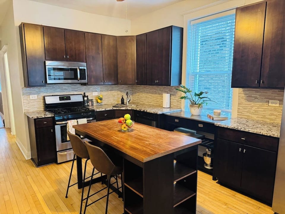 Fully stocked kitchen with large island and modern appliances.