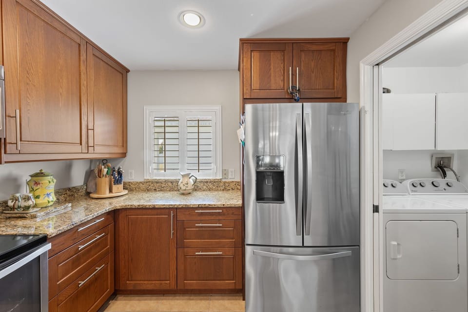 The laundry room is right off the kitchen inside the residence