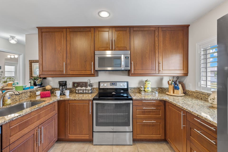 The kitchen has plenty of room and stainless steel appliances