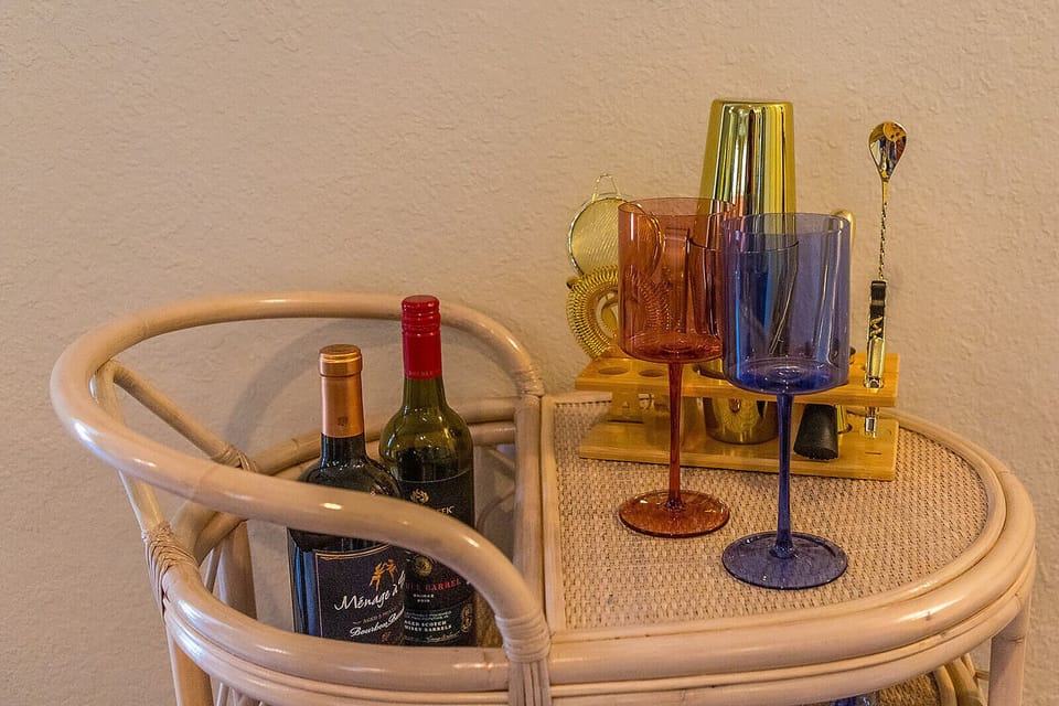 Beverage cart with wine glasses with wine bottles