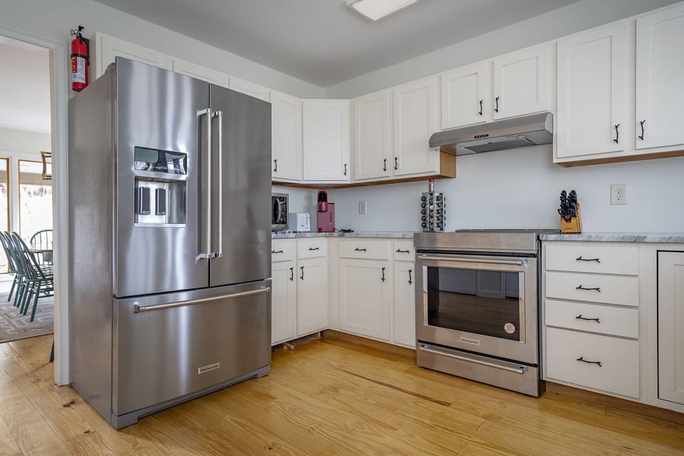 Kitchen with stainless appliances, dishwasher & Keurig coffeemaker.