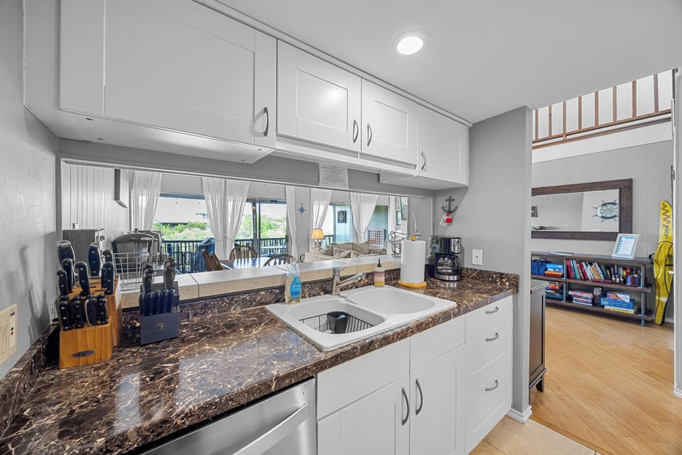 Stocked kitchen w pots, pans, plates, glass wear, silverware & meal prep items.