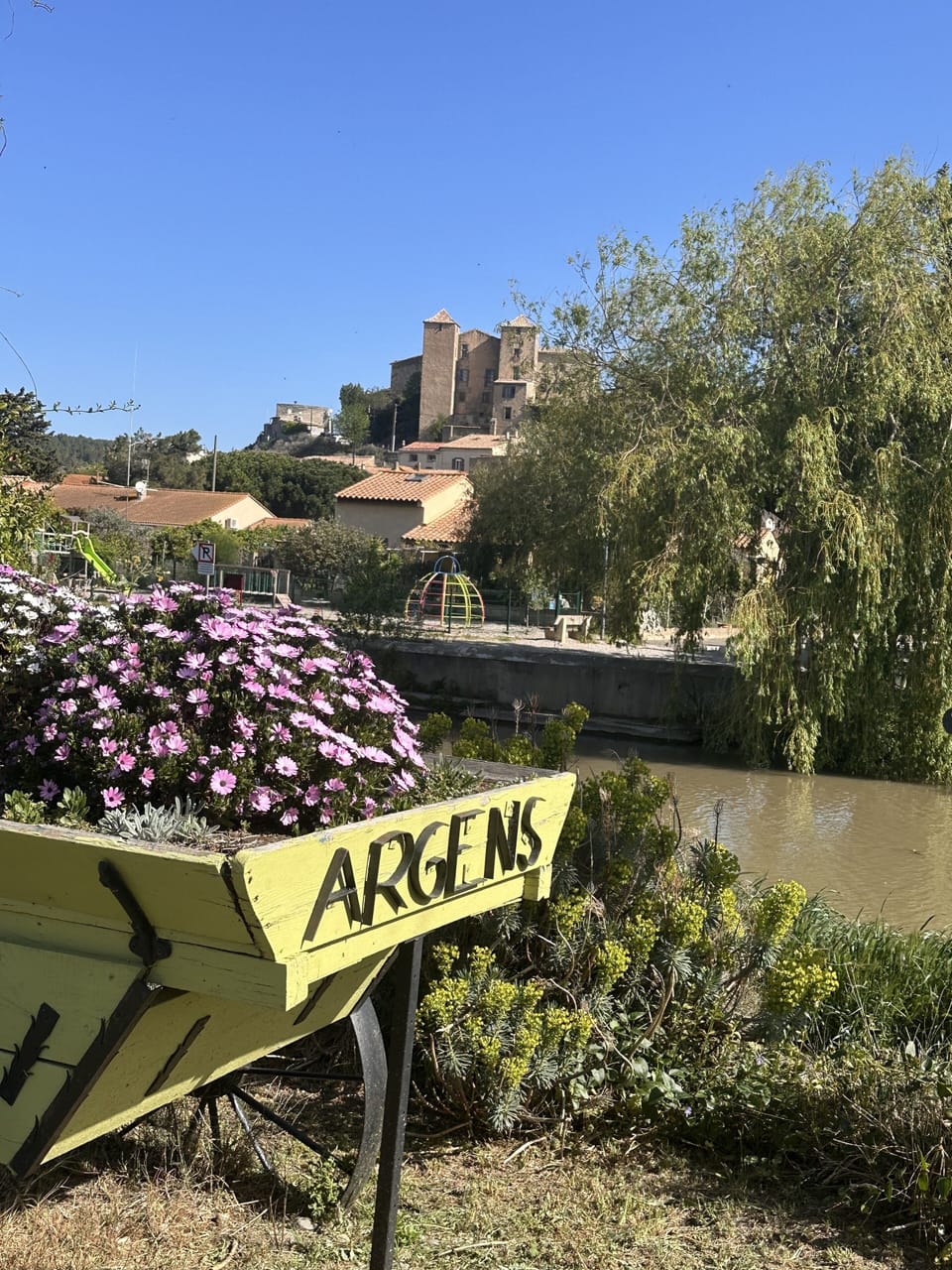 Argens-Minervois.  View of the canal du midi, children’s playground and chateau.