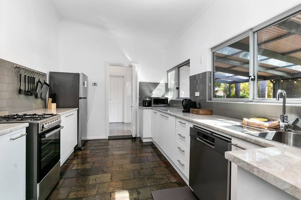 A modern kitchen encourages you to whip up a feast with high-quality appliances and cooking utensils.
