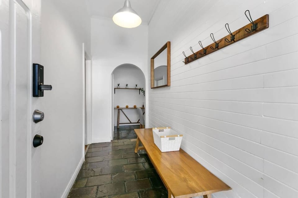 At the entry, the hallway offers hooks to hang your coats and space for your shoes.
