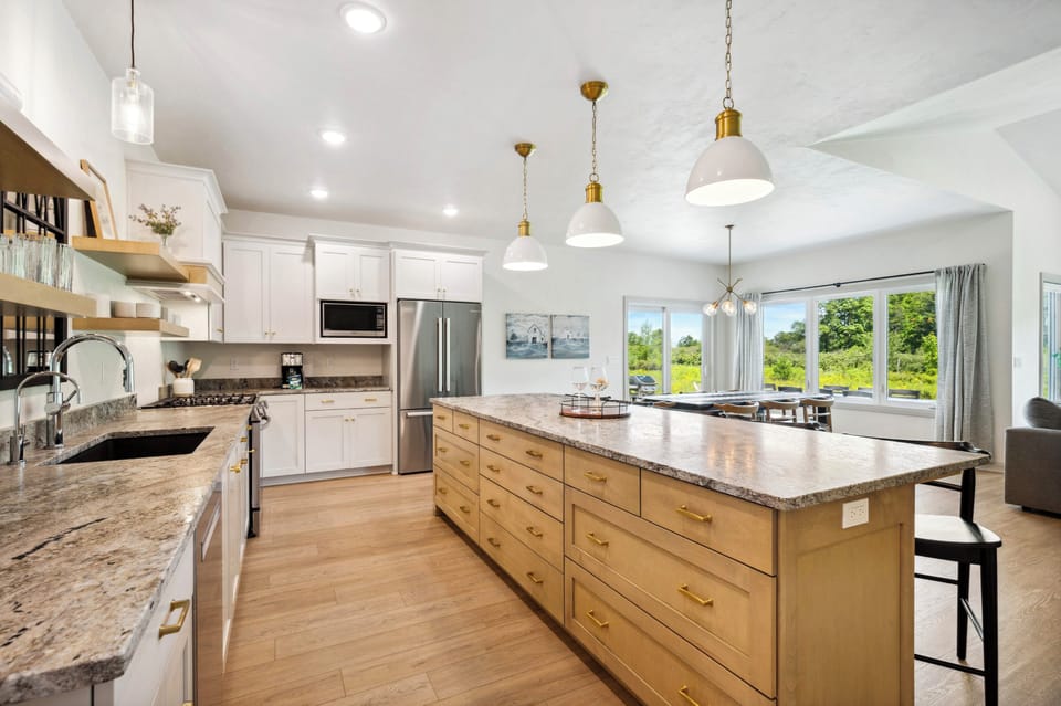 Kitchen overlooks the dining room table and has view of the Orchard!