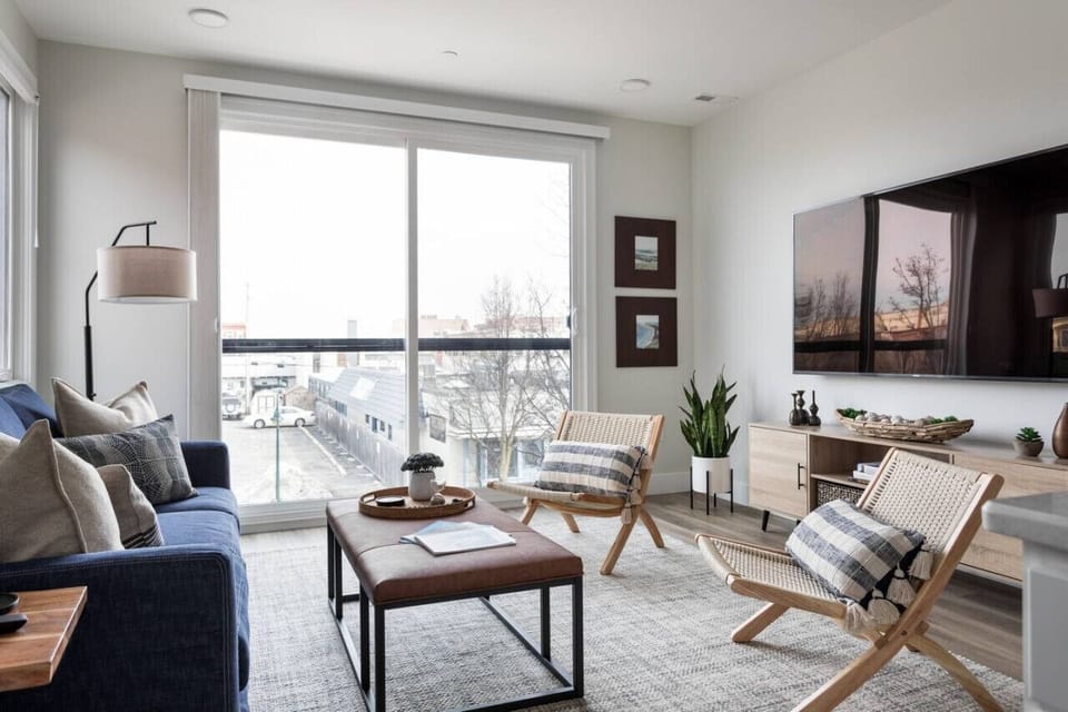 A view of the living room, tv, and a view of downtown Traverse City