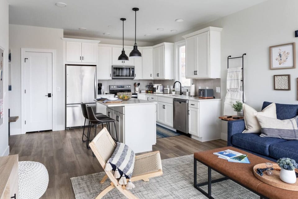The kitchen is fully stocked, has an island, and has bar seating