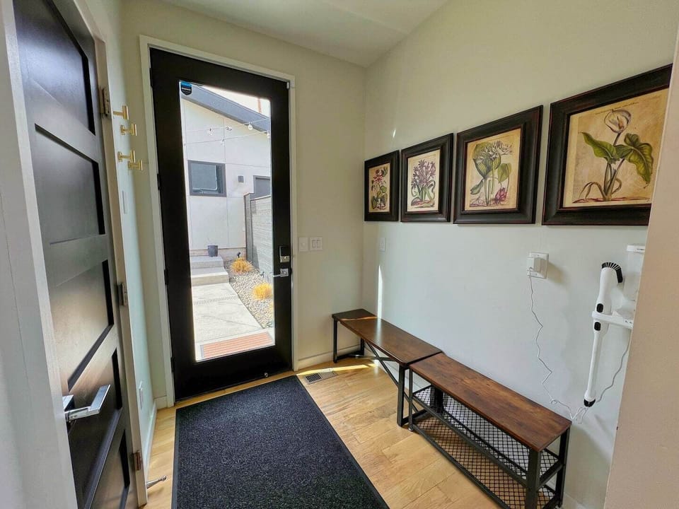 Another view of seating area by door leading to backyard. On the left is door to half bath