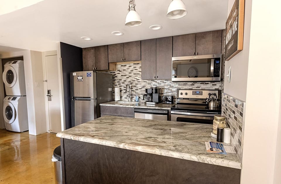 The modern kitchen, with stainless steel appliances, is a great place to make a snack, a gourmet meal, or anything in between!