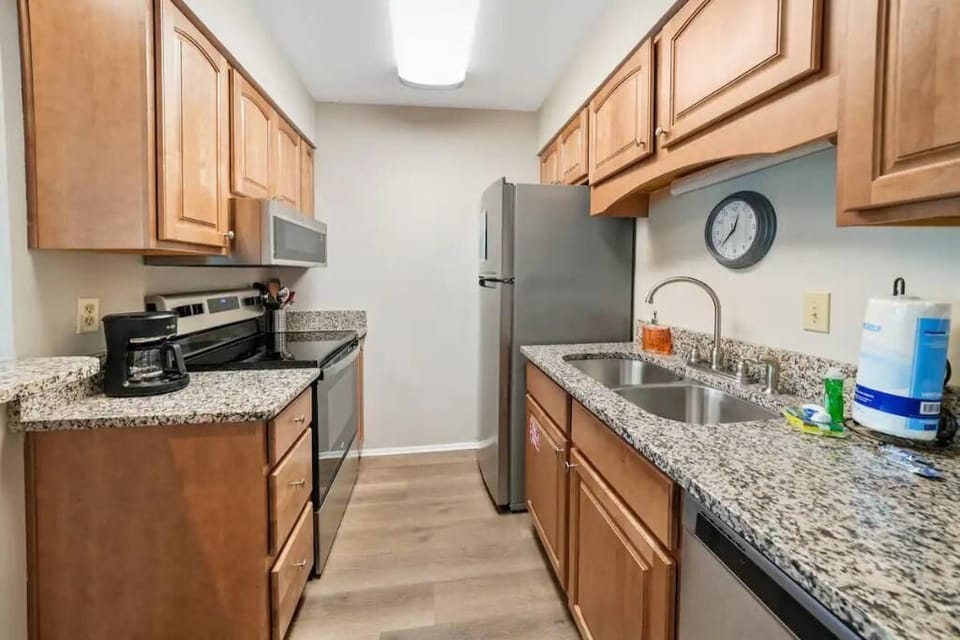 Full kitchen with new appliances, dishes, and cooking utensils. 