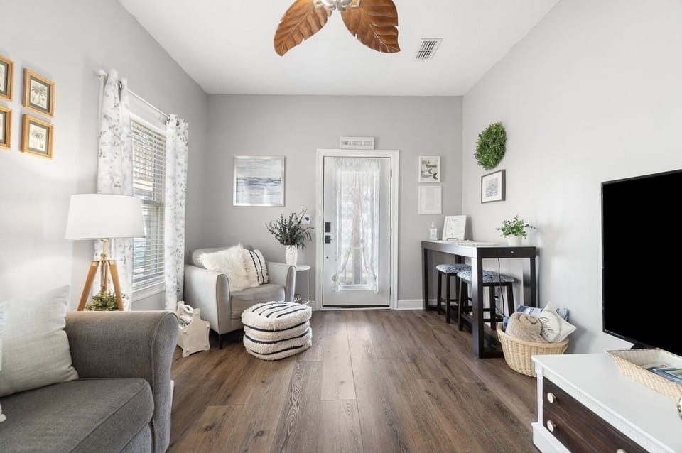 Cozy Living Room with Large Streaming Television and Eating Area