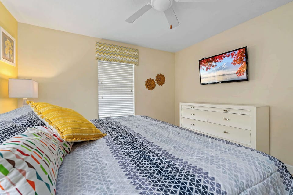 Bedroom w/ bed and bright accents for a cheerful stay.