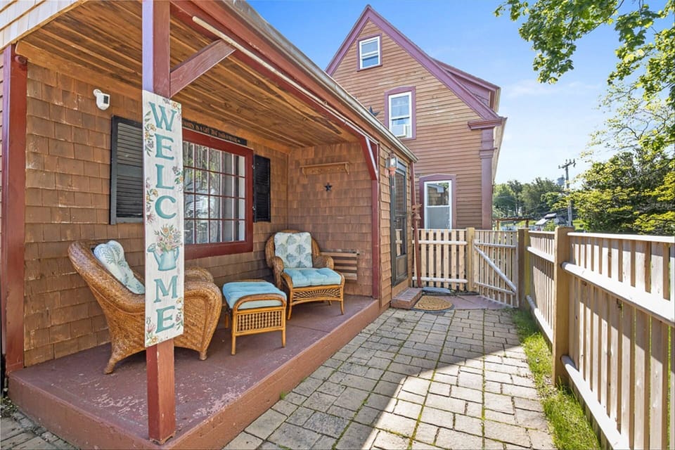 Covered outdoor seating area in the fenced-in portion of the yard