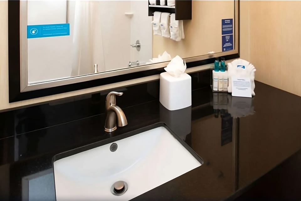 Refresh at the sleek vanity with bright, clean lighting.
