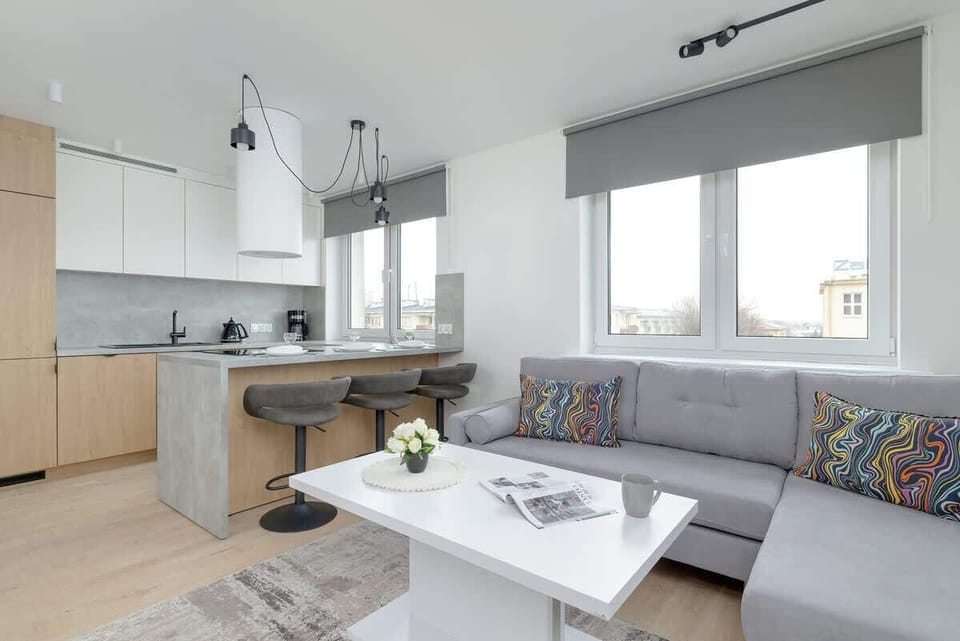 A wider shot of the living room and kitchen area, showing a well-designed open-concept space.

