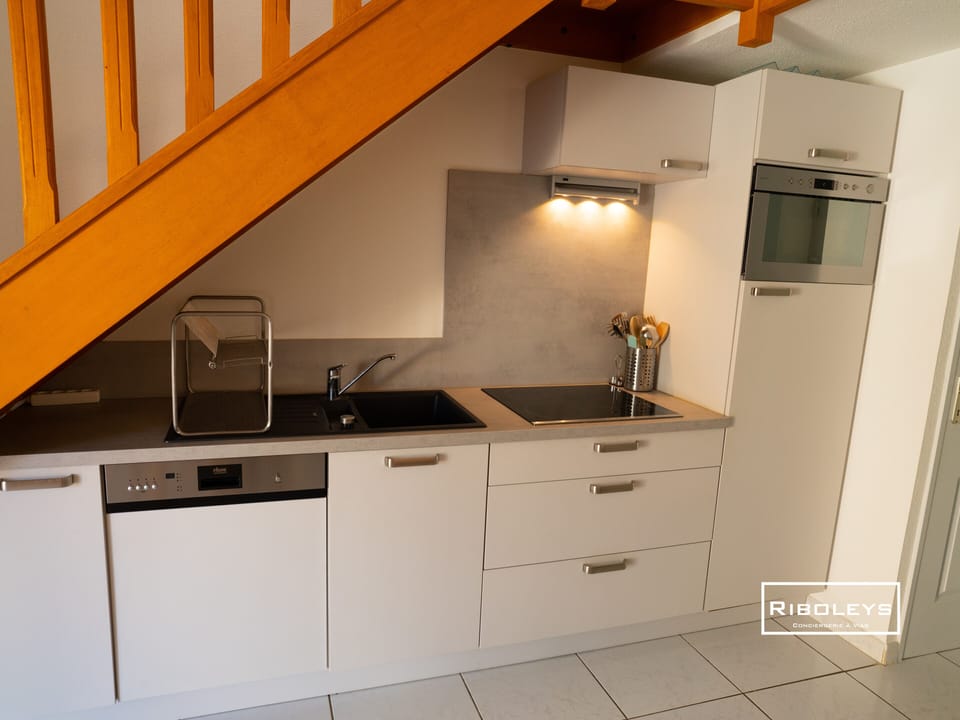 Air-conditioned living room with kitchen, sofa and dining area