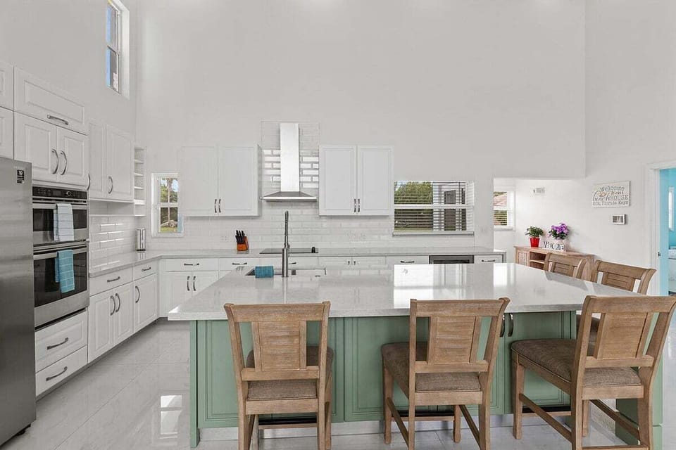 Share meals around the large dining table, conveniently positioned beside Aqua Vista's bright and fully equipped kitchen.