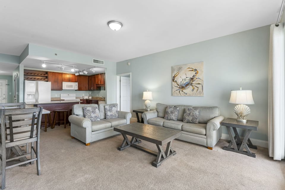 Spacious living area with comfortable seating and an open kitchen layout.