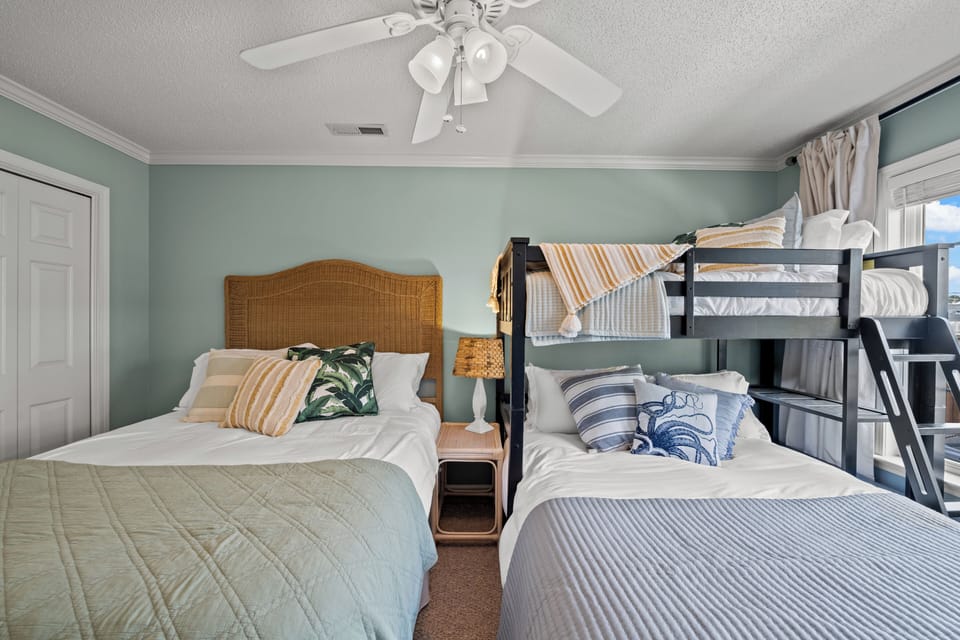 Two queen size beds and a twin bunk