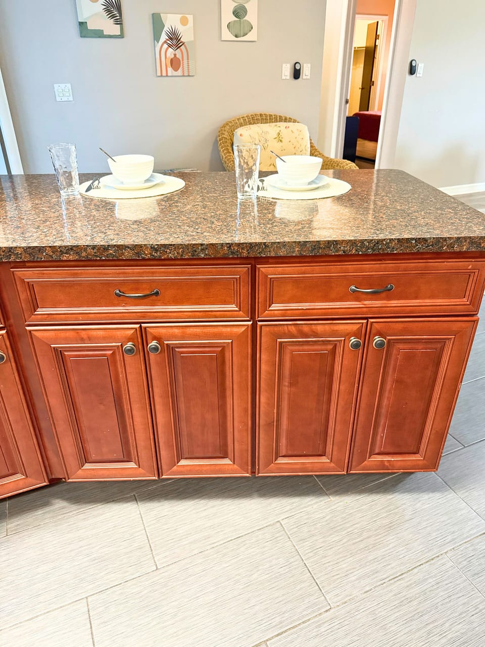 Kitchen features essential appliances, also includes a counter with 2 bar stools