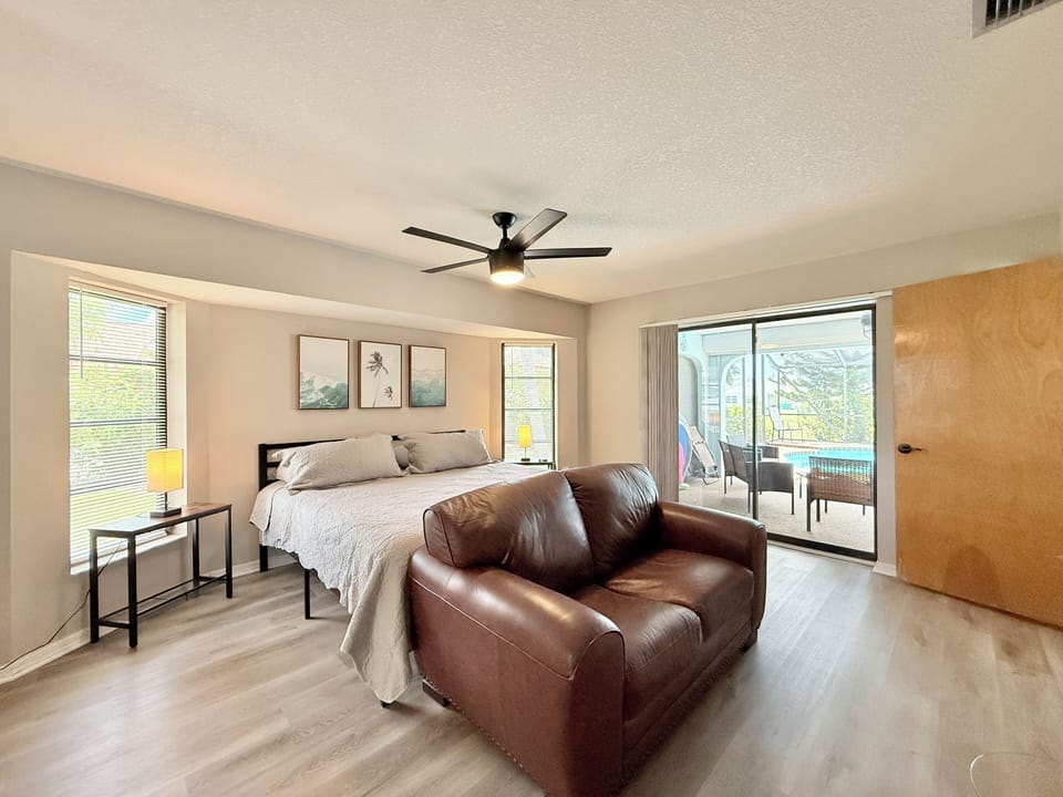 Master Bedroom has a King-size bed, a TV, bathroom & direct pool access.
