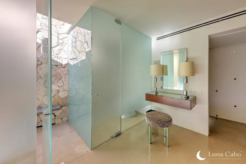 A sleek space with a glass shower and vanity.