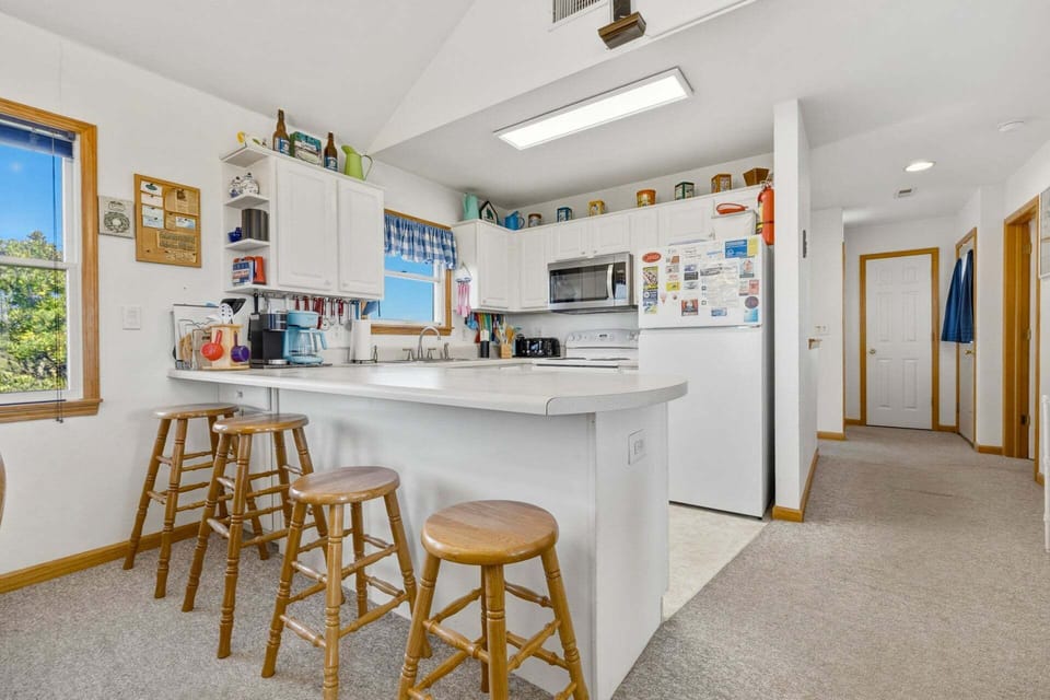 Additional seating at the breakfast bar makes it easy to gather for quick bites or conversation.