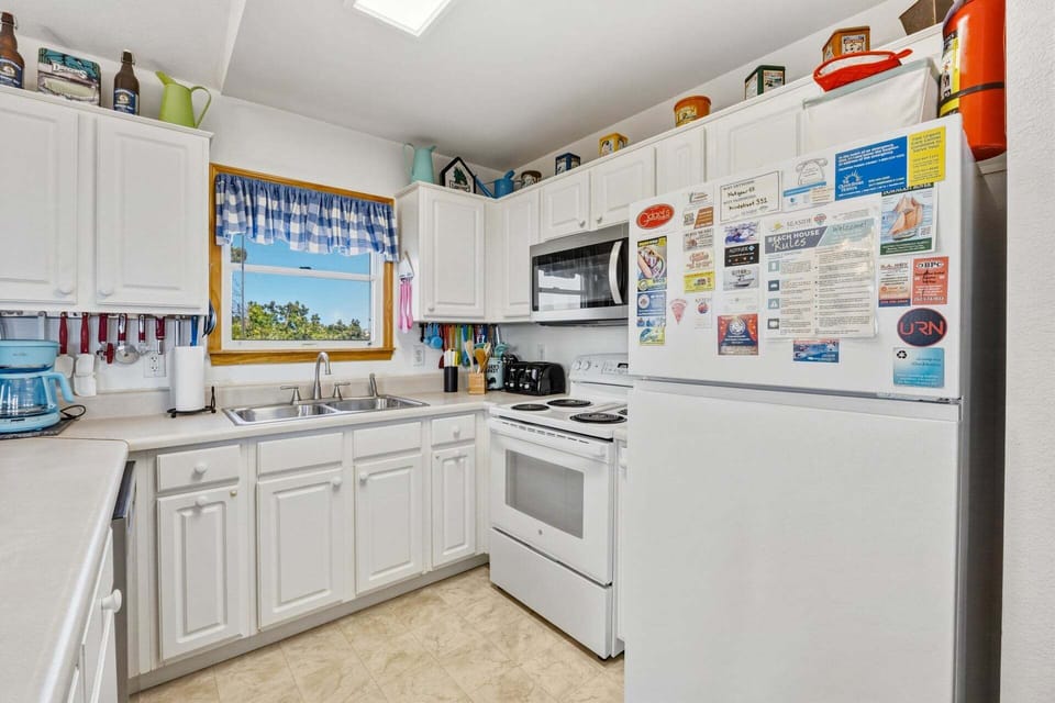Prepare meals with ease in the fully equipped kitchen featuring modern appliances and ample counter space.