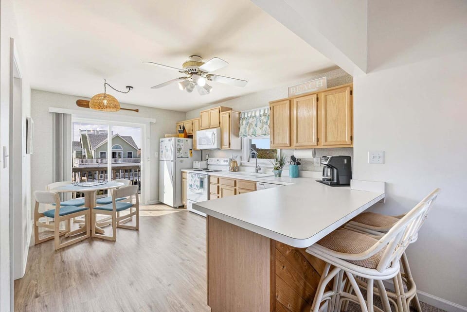The spacious kitchen provides an additional eating space, perfect for breakfast, coffee, or a family board game!
