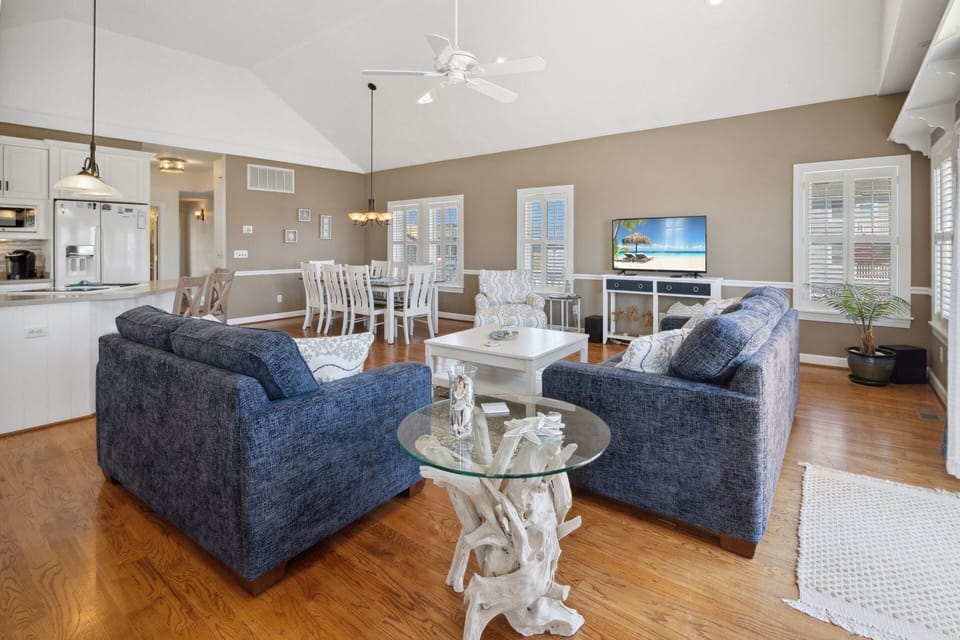 The spacious Living Area with a Flat Screen TV and views of the ocean is your dream home base!