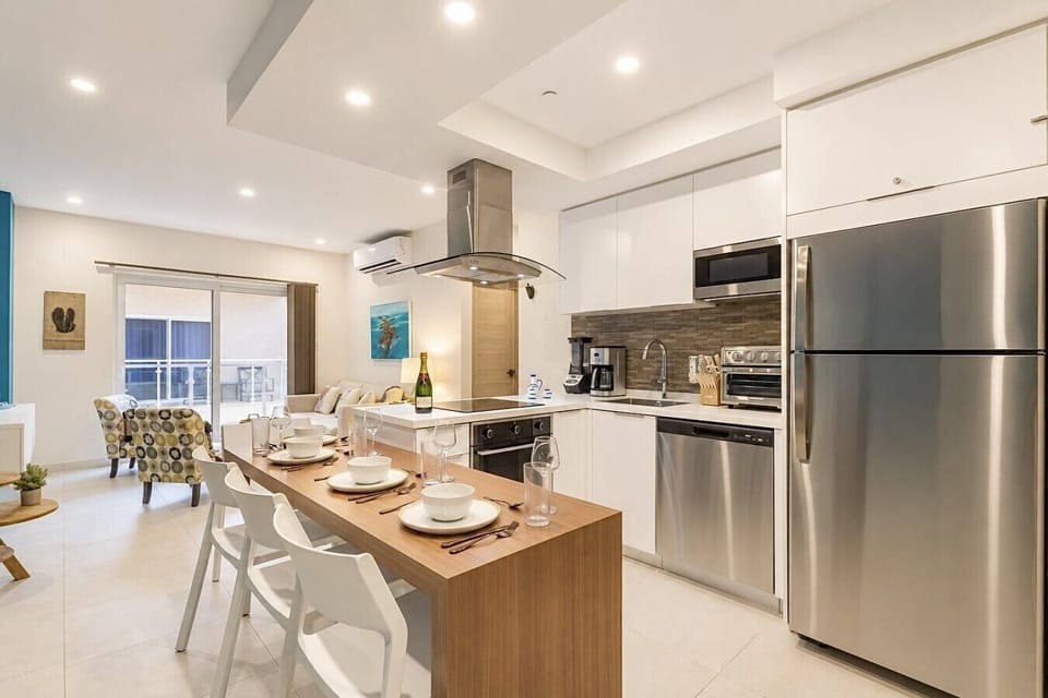 Fully equipped kitchen featuring modern appliances, cookware, essentials, and ample space for meal preparation.