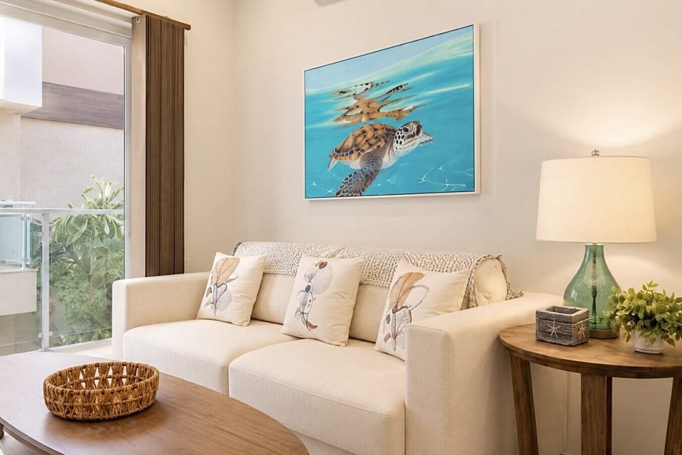 Cozy living room with comfortable seating, smart TV, natural light, and inviting atmosphere.