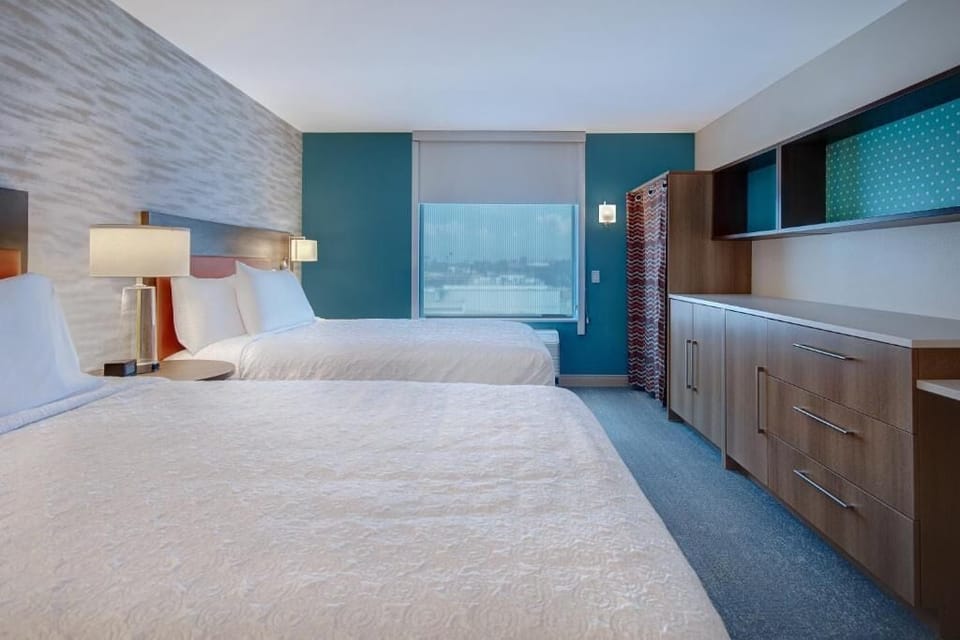 Unwind in crisp linens with calming city-view daylight.