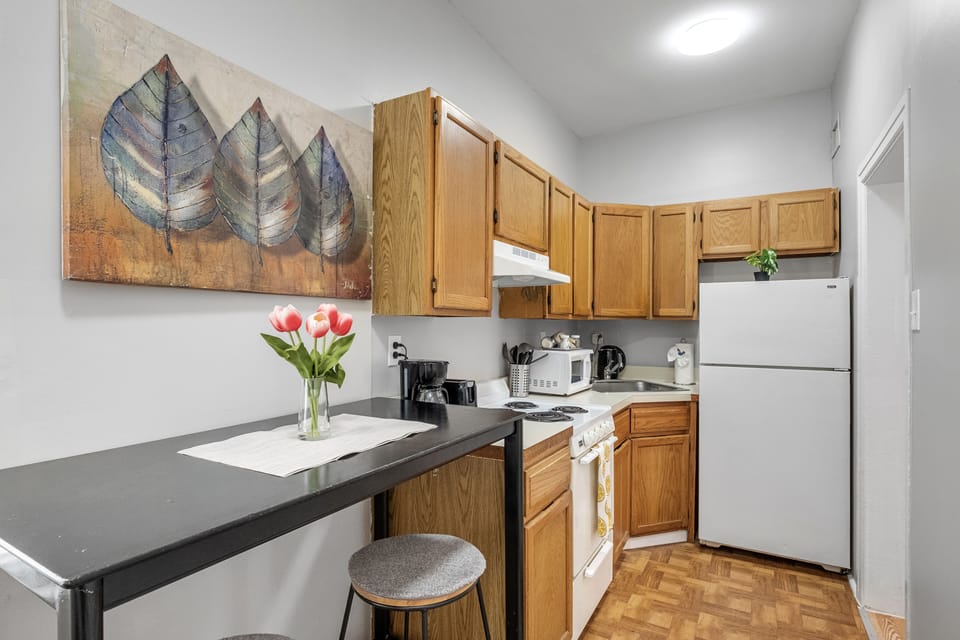 Fully stocked kitchen with all cookware, dishware and flatware needed.   Plus a work from home tall table for eating and home study time.