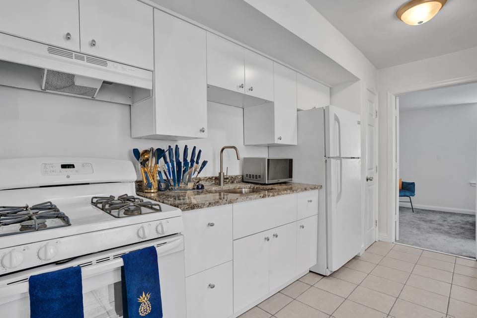 Compact kitchen with upper and lower wooden cabinets