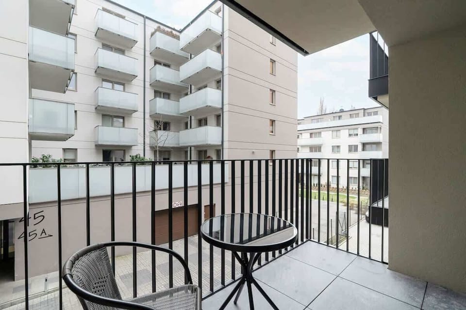 The spacious balcony with table and chair is conducive to enjoying a coffee outdoors. 