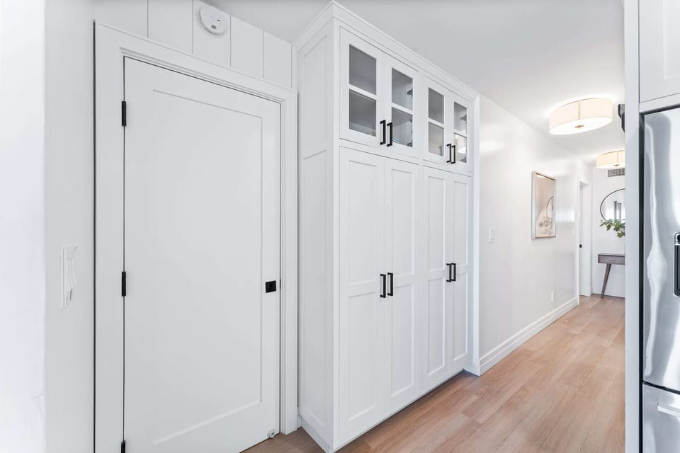 The washer and dryer are neatly tucked away behind this door.